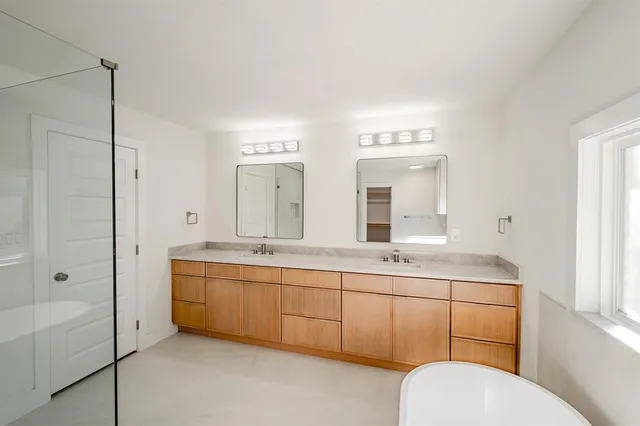 a bathroom with a toilet sink and mirror