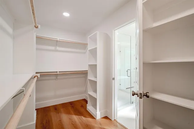 a view of walk in closet with empty racks