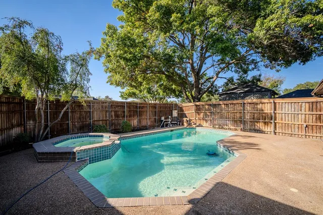 a backyard of a house with barbeque oven