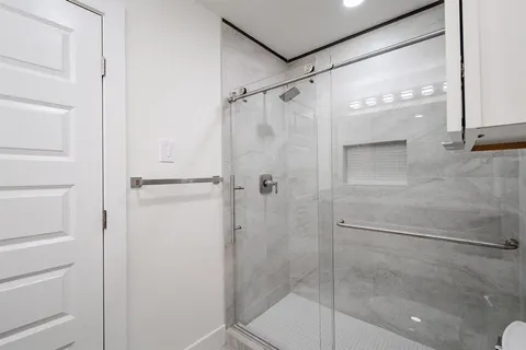 a bathroom with a glass shower door