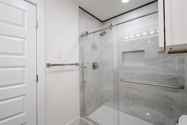 a bathroom with a glass shower door