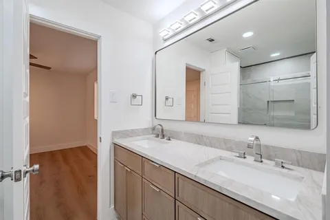 a bathroom with a double vanity sink and a mirror