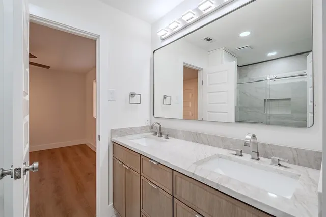 a bathroom with a double vanity sink and a mirror