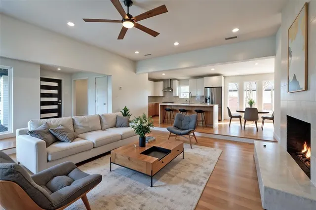 a living room with furniture a fireplace and a flat screen tv