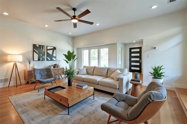a living room with furniture and a large window