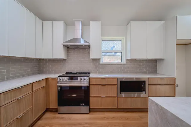 a kitchen with stainless steel appliances granite countertop a stove and a sink