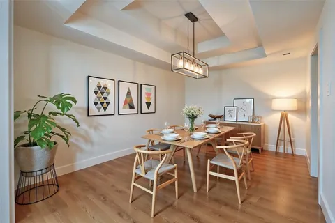 a view of a dining room with furniture wooden floor and chandelier