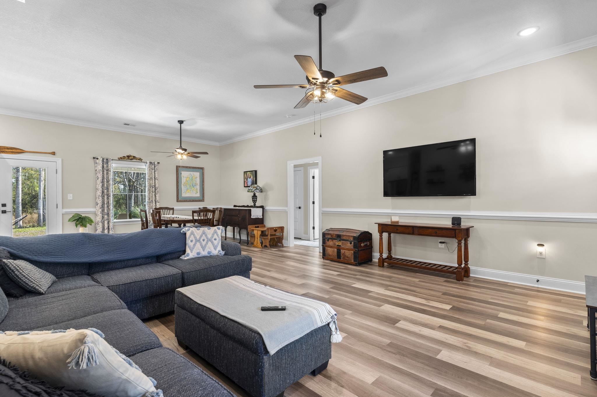 3394 Dusty Road Loris, SC 29569 - Photo 14 of 37 Living area featuring wood finished floors, crown molding, and a ceiling fan