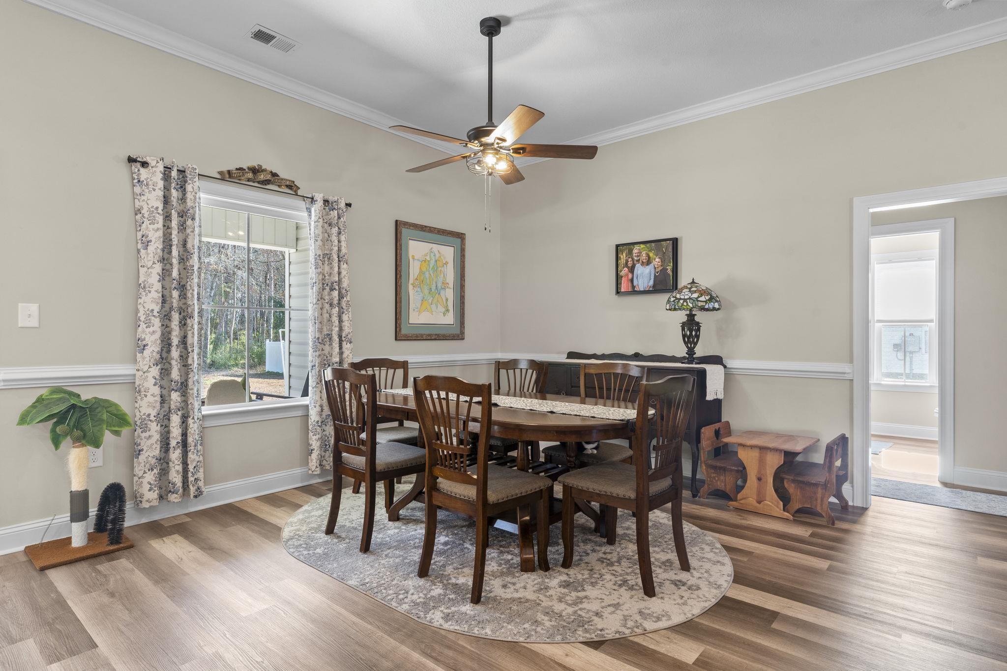 3394 Dusty Road Loris, SC 29569 - Photo 19 of 37 Dining area featuring wood finished floors, ornamental molding, and a ceiling fan