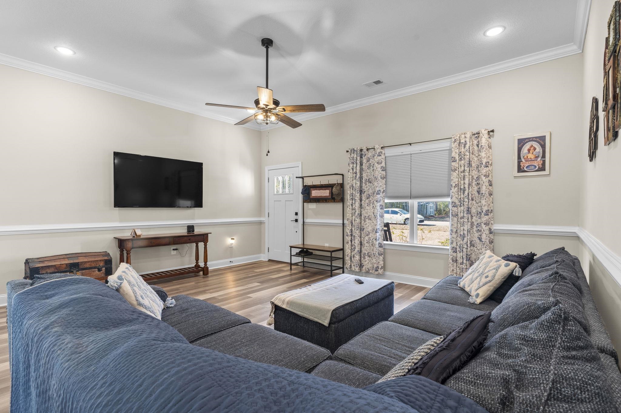 3394 Dusty Road Loris, SC 29569 - Photo 25 of 37 Living area featuring crown molding, wood finished floors, a ceiling fan, and recessed lighting