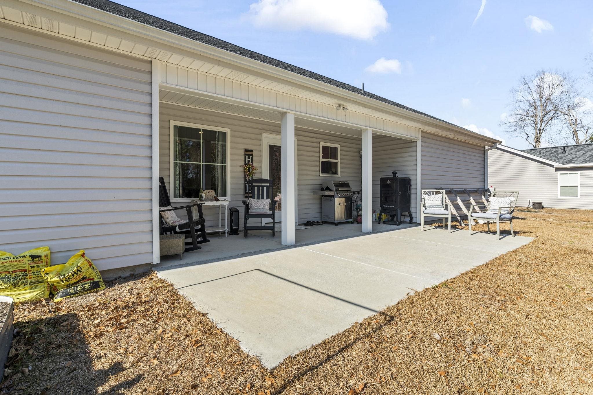 3394 Dusty Road Loris, SC 29569 - Photo 27 of 37 Rear view of property featuring roof with shingles and a patio