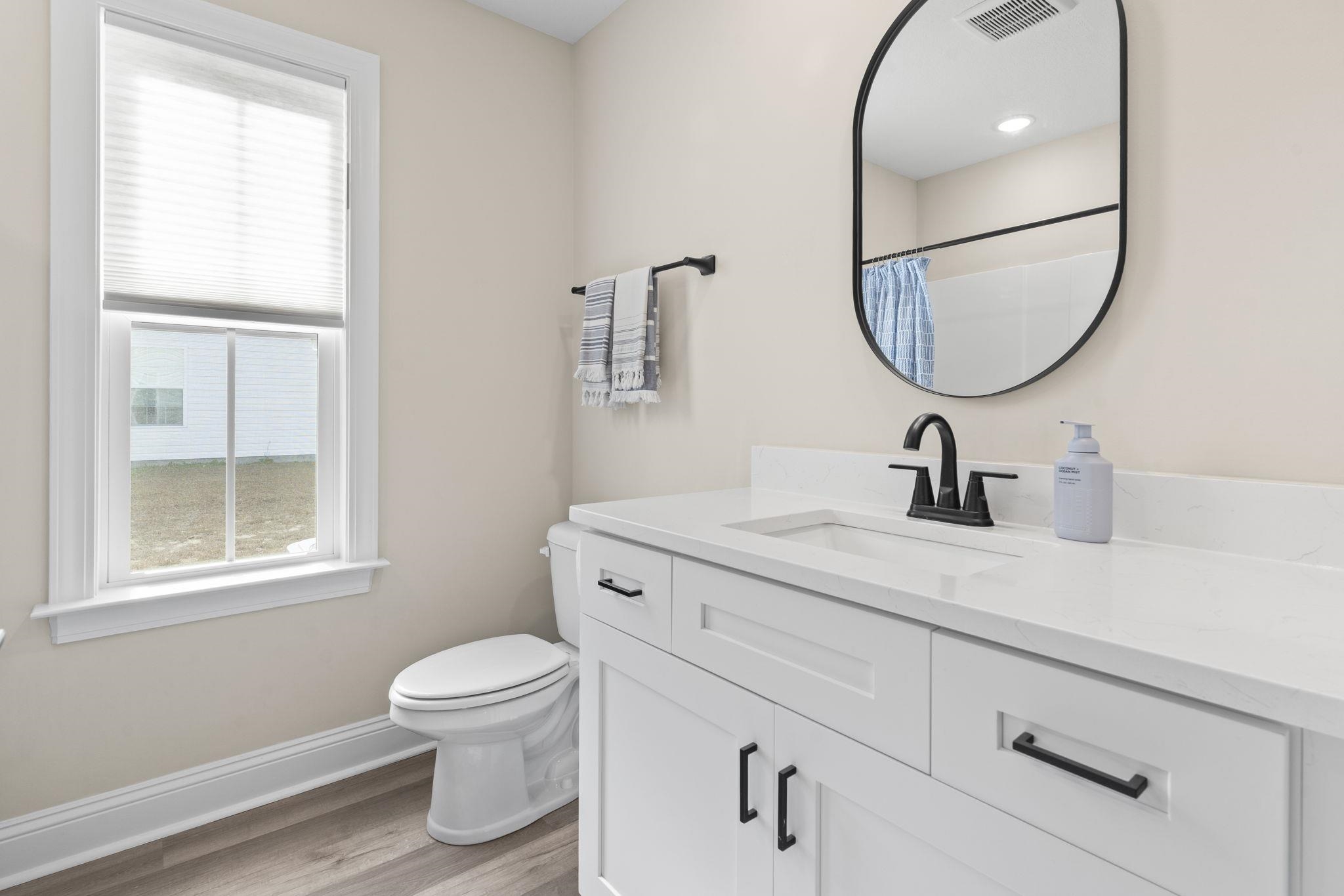3394 Dusty Road Loris, SC 29569 - Photo 6 of 37 Bathroom with vanity, light wood-type flooring, and curtained shower