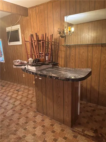 a view of a room with furniture and a chandelier