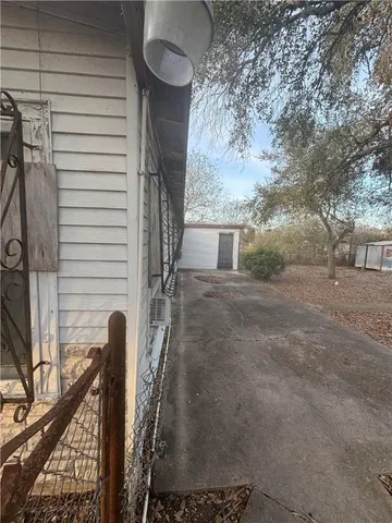 a view of a backyard with large trees