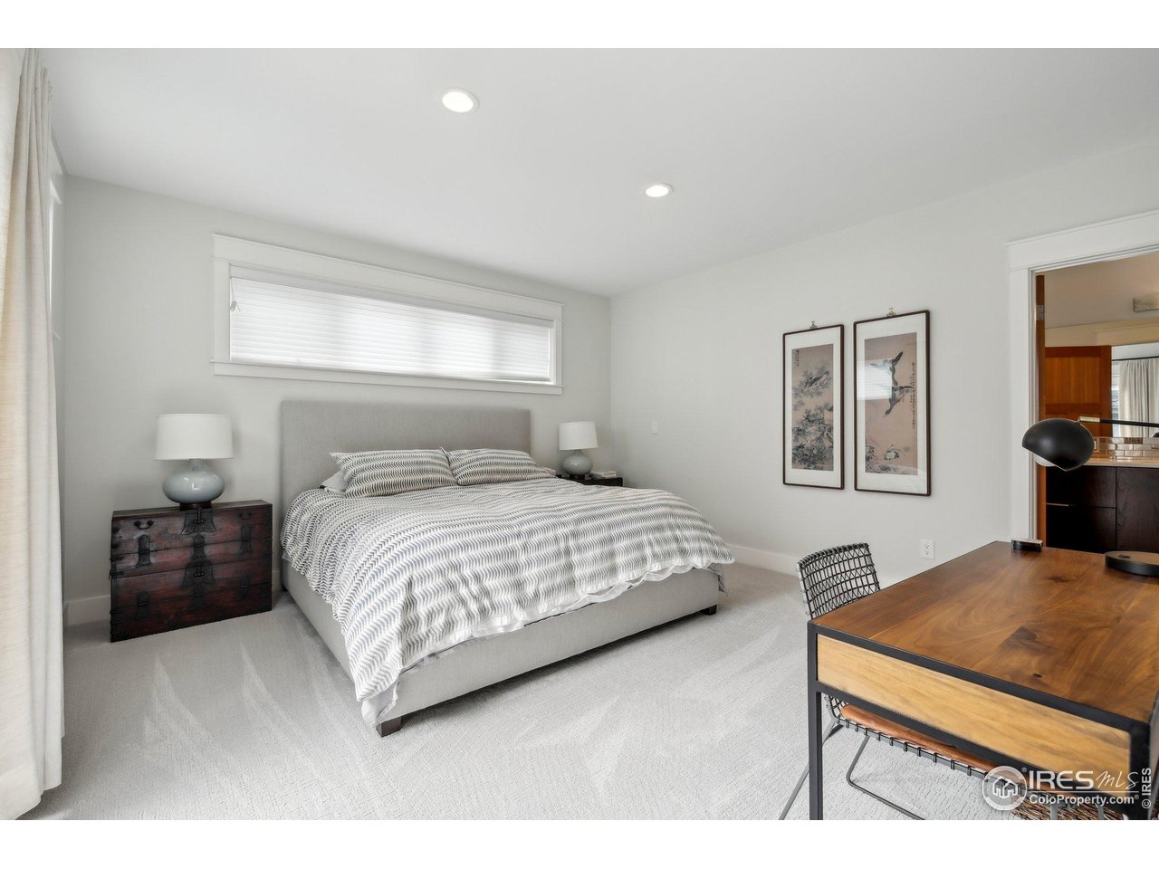 2917 13th Street Boulder, CO 80304 - Photo 11 of 40 a bedroom with a bed and a tv on the dresser