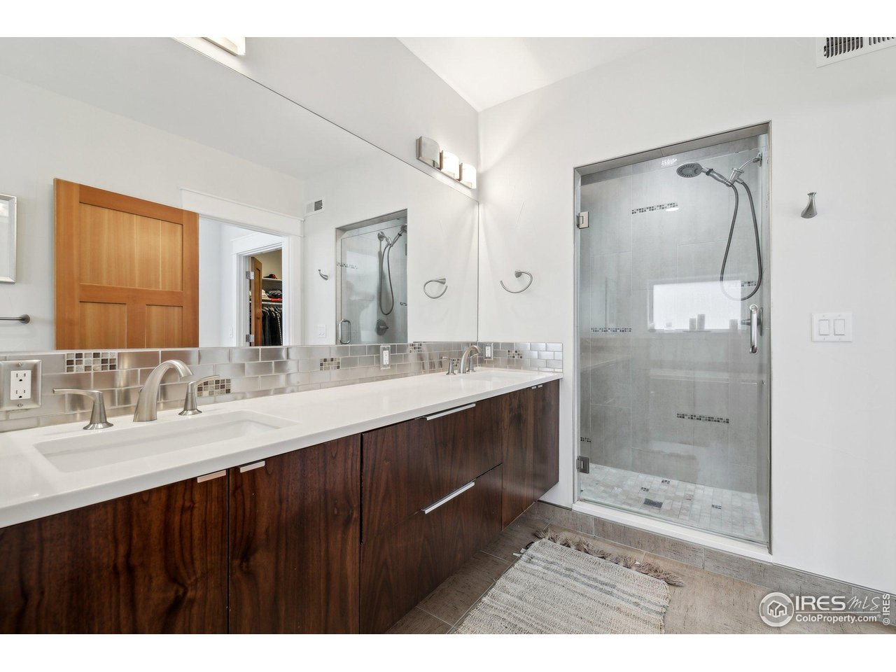 2917 13th Street Boulder, CO 80304 - Photo 14 of 40 a bathroom with a sink mirror and a shower