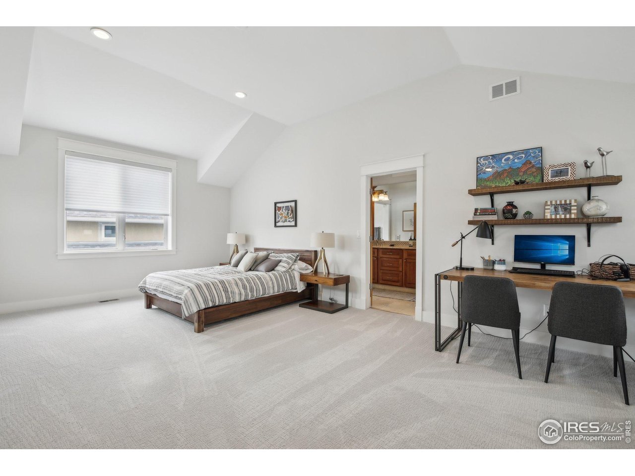 2917 13th Street Boulder, CO 80304 - Photo 15 of 40 a spacious bedroom with a bed a couch and a window