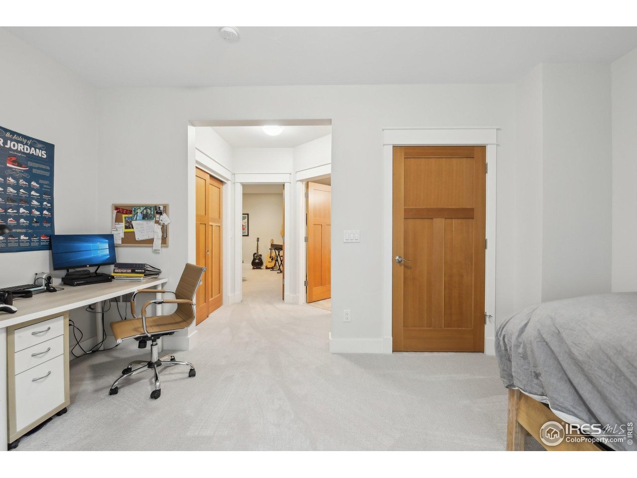 2917 13th Street Boulder, CO 80304 - Photo 25 of 40 a bedroom with a bed and a desk