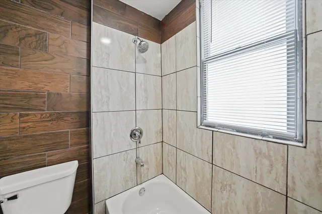 a bathroom with a toilet and a shower