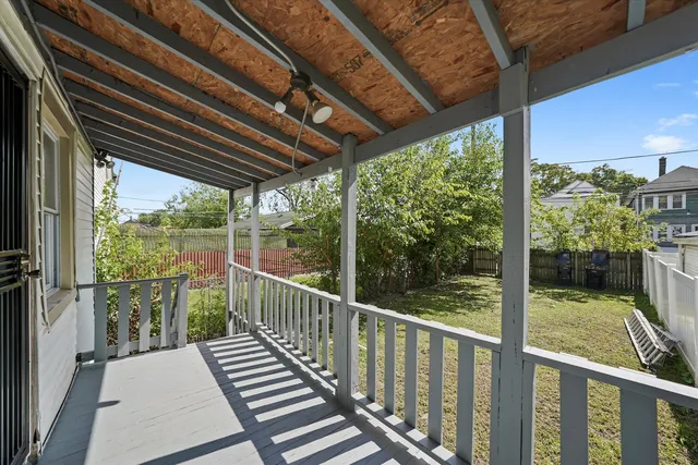a view of a balcony with wooden floor