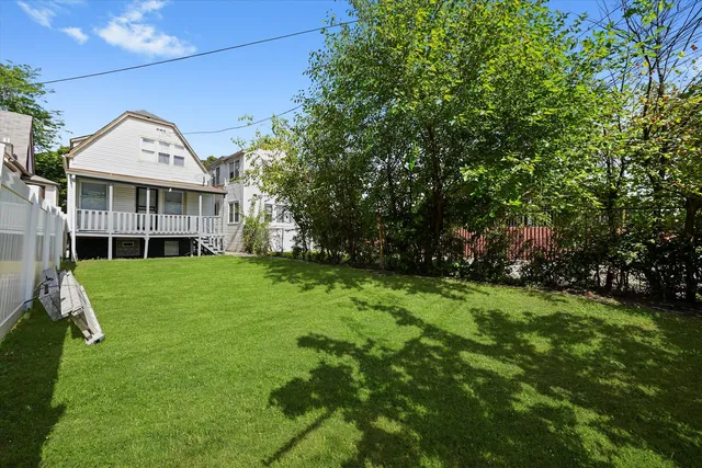 a view of a house with a backyard
