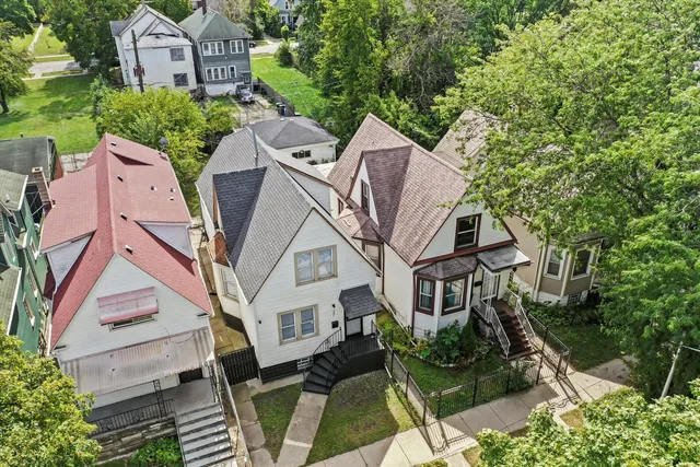 an aerial view of a house with a yard lake and outdoor seating