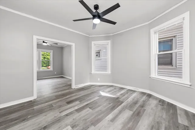 a view of a livingroom with a window and wooden floor
