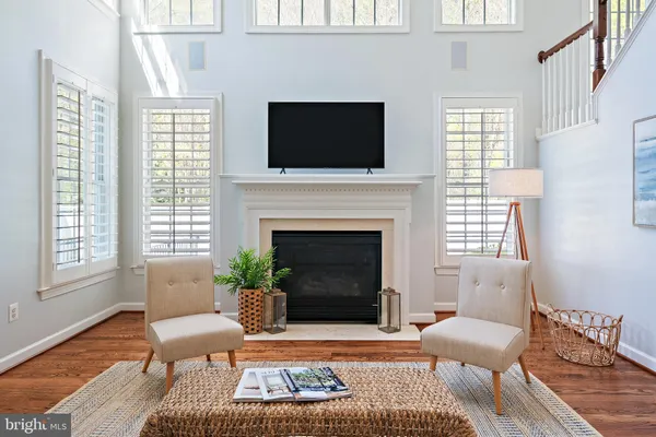 a kitchen with stainless steel appliances granite countertop a sink a stove a refrigerator and island with wooden floor