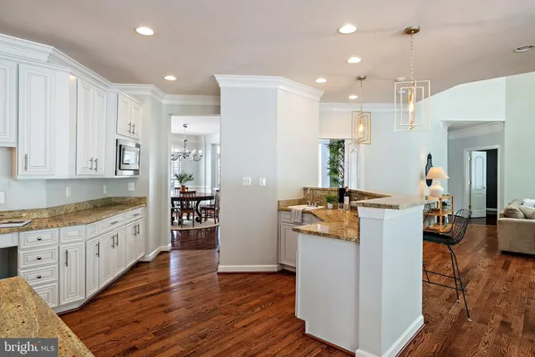 a view of a hallway with wooden floor fireplace and dining room