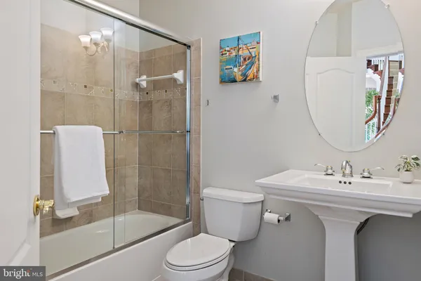 a spacious bathroom with a shower a sink and a mirror
