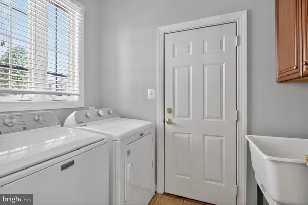 a view of staircase with railing and white walls