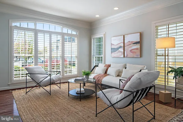 a living room with furniture a dining table and a chandelier