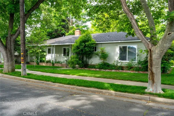 a front view of house with yard and green space