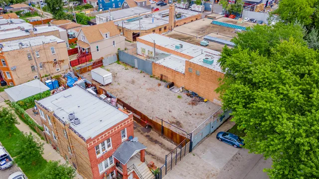 an aerial view of a house with a yard