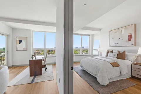 a bedroom with a bed and glass door