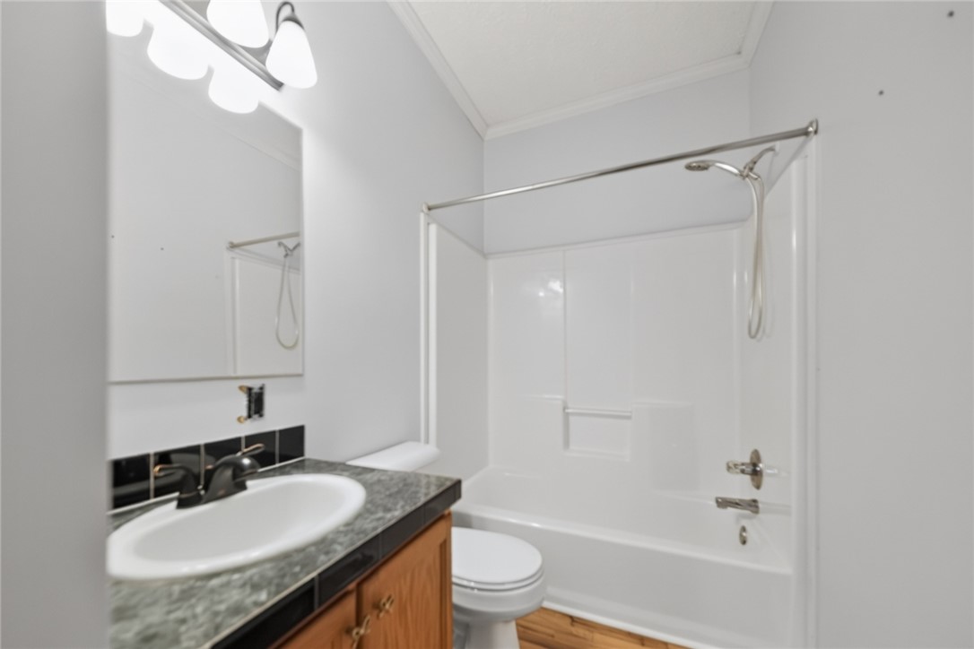 564 Fairfield Road Walhalla, SC 29691 - Photo 26 of 50 Wood flooring and a stone-look vanity top add classic elements to this bathroom design.