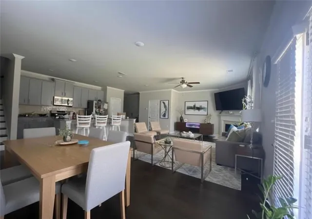 a living room with lots of furniture and kitchen view