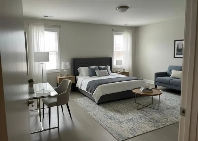 a bedroom with a bed and wooden floor