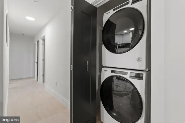 a close view of a utility room with dryer and washer