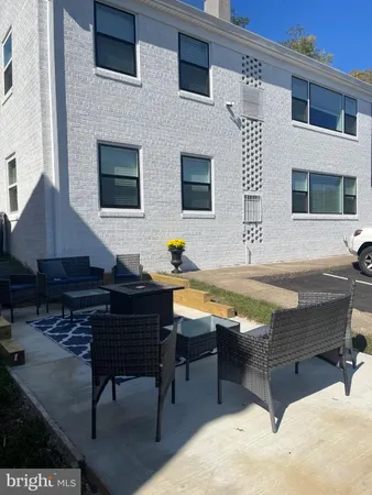 a swimming pool with outdoor seating and yard