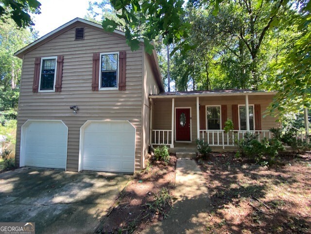 5389 Martins Crossing Road Stone Mountain, GA 30088 - Photo 29 of 30 a front view of house with yard and trees around