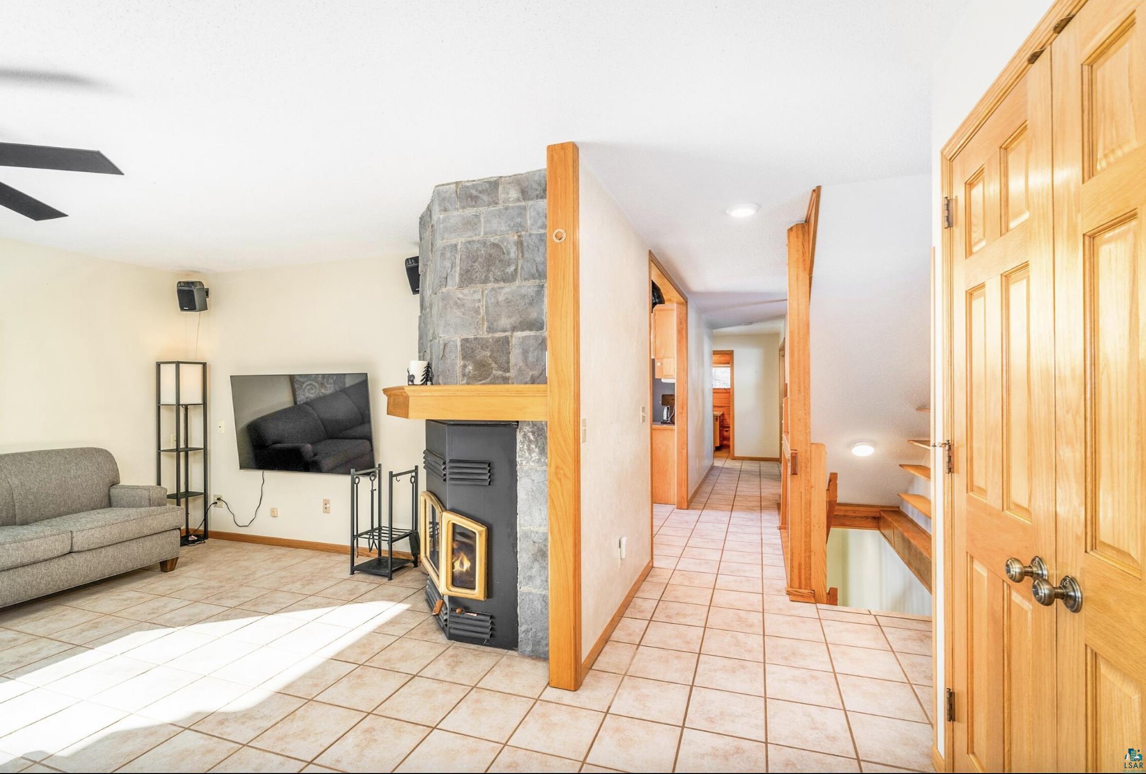 1480 Devil Track Road Grand Marais, MN 55604 - Photo 17 of 38 Living room featuring light tile patterned flooring and a ceiling fan