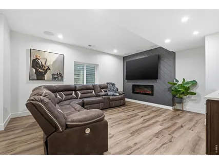 a living room with furniture a wooden floor and sink