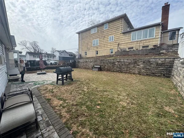 a backyard of a house with outdoor seating