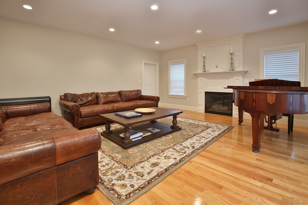 100 Drumlin Road Newton, MA 02459 - Photo 5 of 24 a living room with furniture fireplace and a table