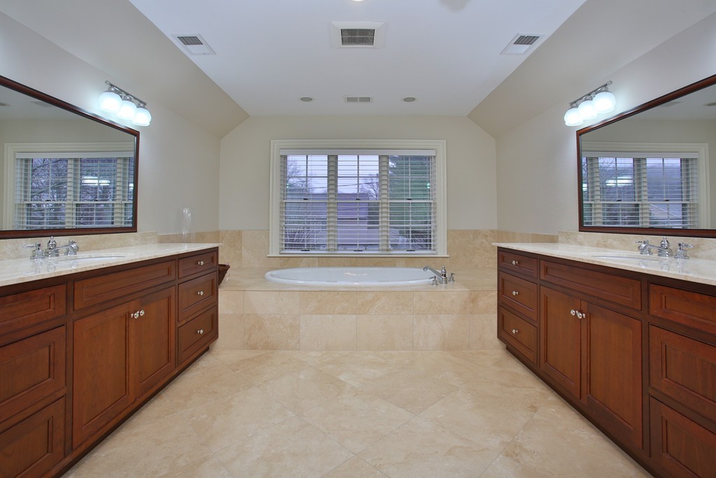 100 Drumlin Road Newton, MA 02459 - Photo 8 of 24 a spacious bathroom with a granite countertop double vanity sink a mirror and a bathtub