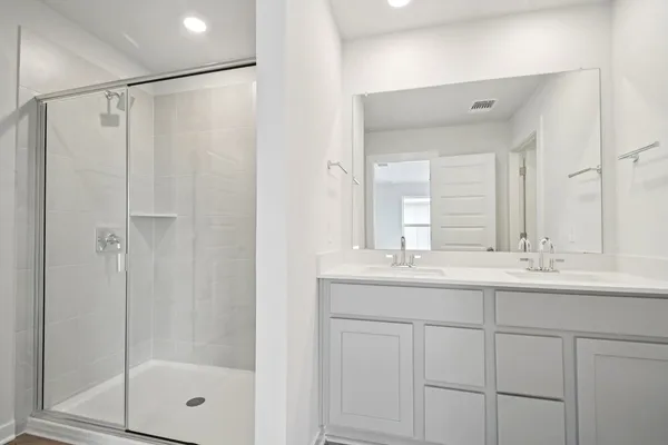 a bathroom with a sink double vanity and a mirror