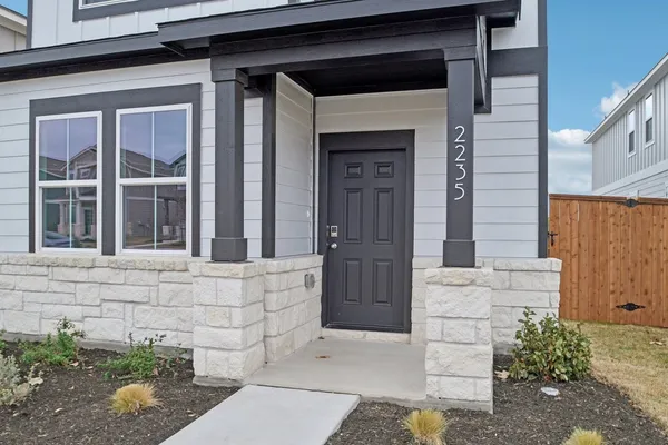 a front view of a house with a plants