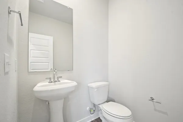 a bathroom with a sink a toilet and mirror