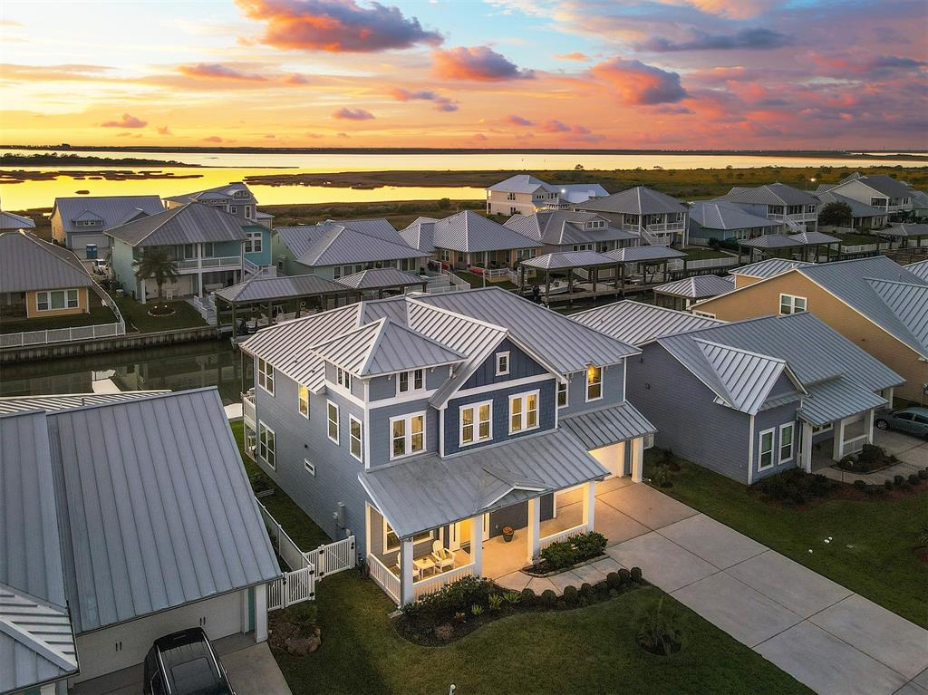 an aerial view of residential houses with outdoor space and ocean view
